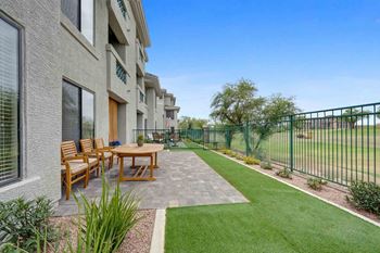 Courtyard-style extended patio with landscaping & turf in select homes